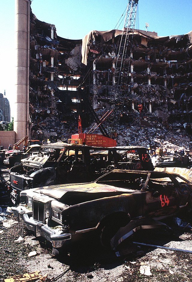 Wikimedia Commons Bombed out Alfred P. Murrah Federal Building with burnt cars in front.
